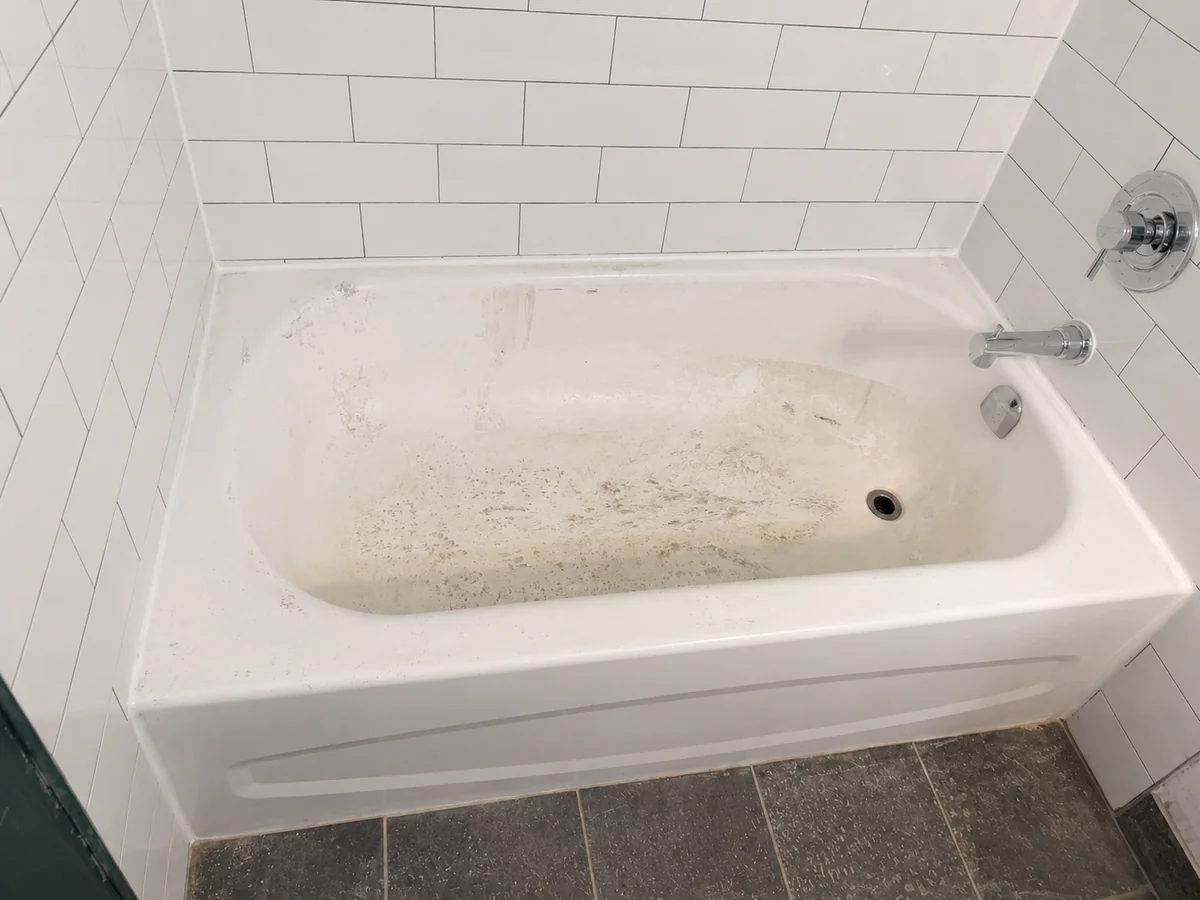 Worn and stained bathtub before professional reglazing